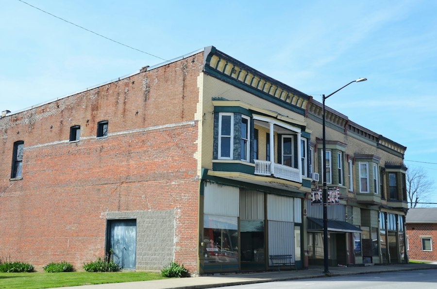 Historic brick storefront building on a small-town street corner