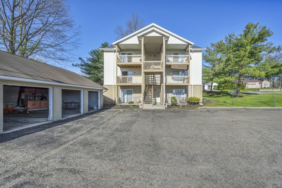 Condo building with wood balconies above an attached garage