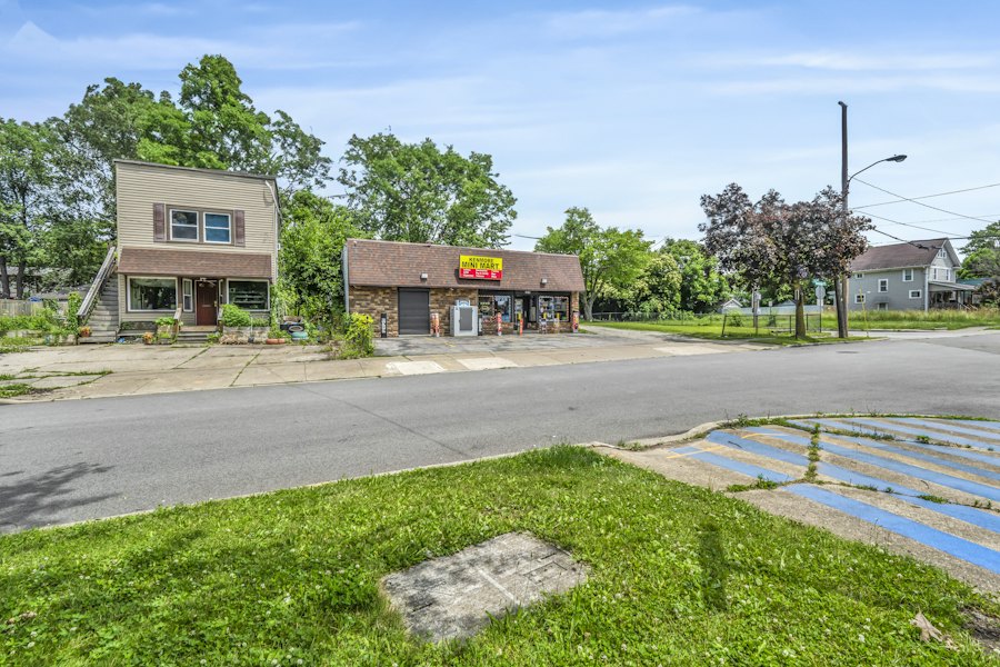 Small brick commercial building on a street corner