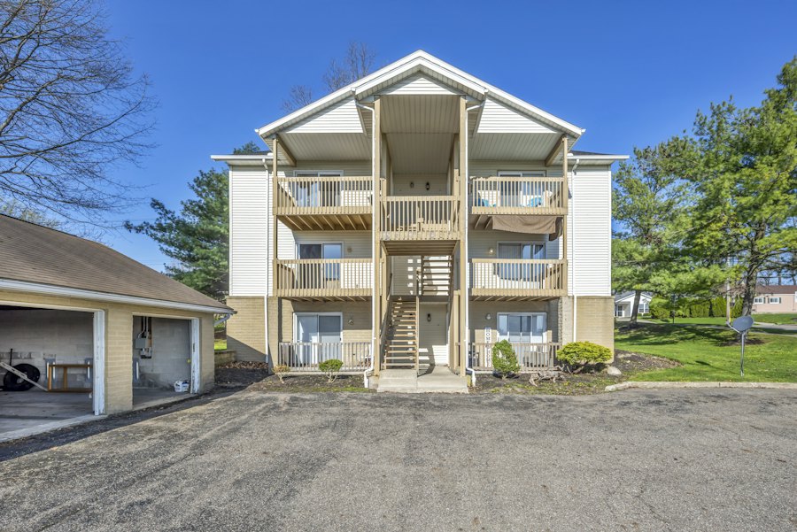 Condo building with balconies and an exterior staircase