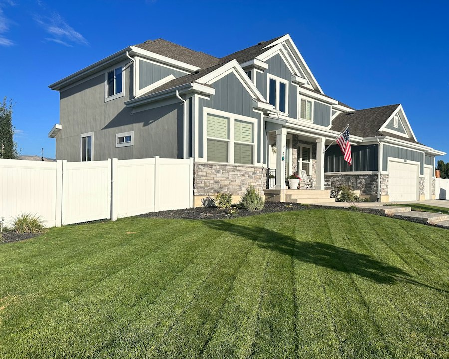 Large two-story house with a stone-accented entrance and attached garage