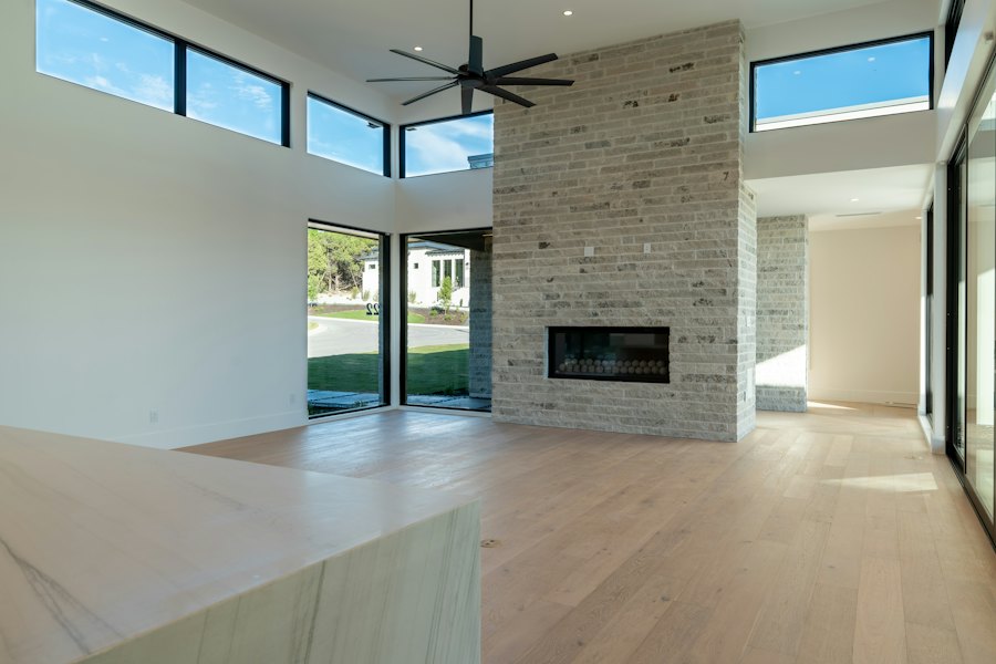 Living room with a tall stone fireplace and clerestory windows